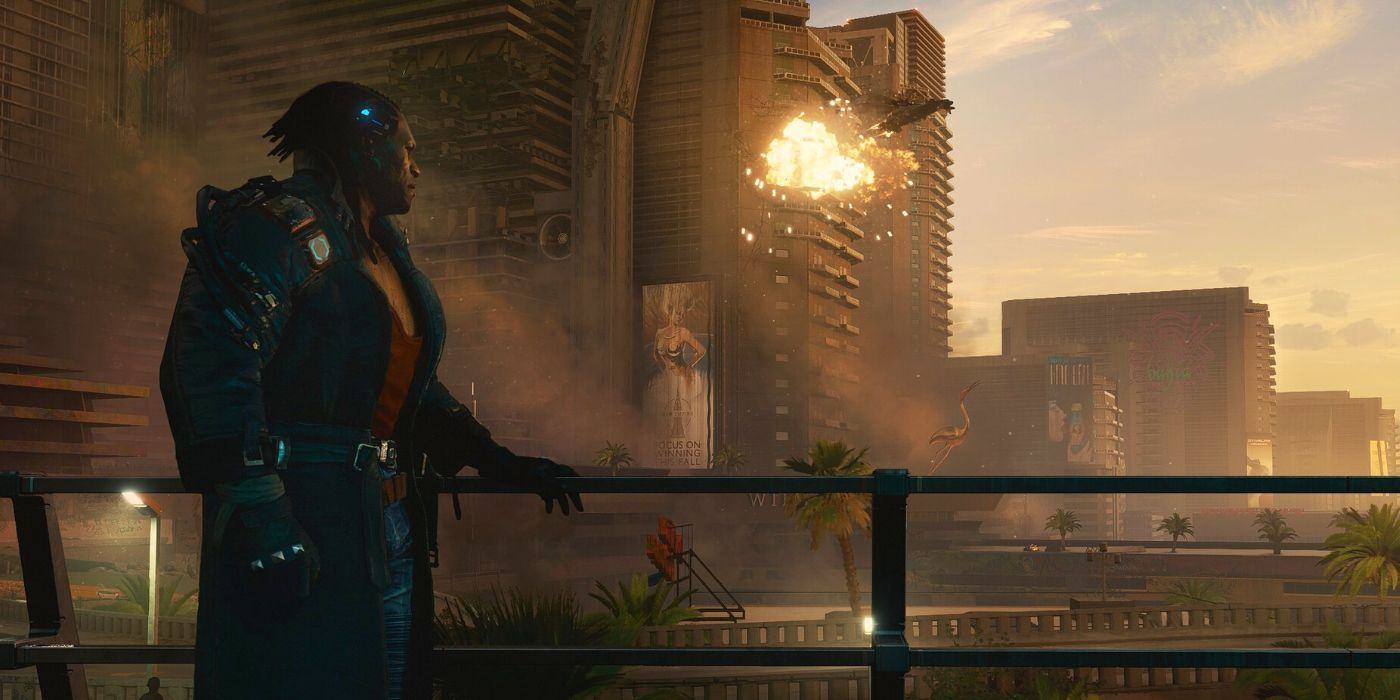 Cyberpunk 2077's Placide sits next to a balcony overlooking Pacifica as buildings explode in the distance.