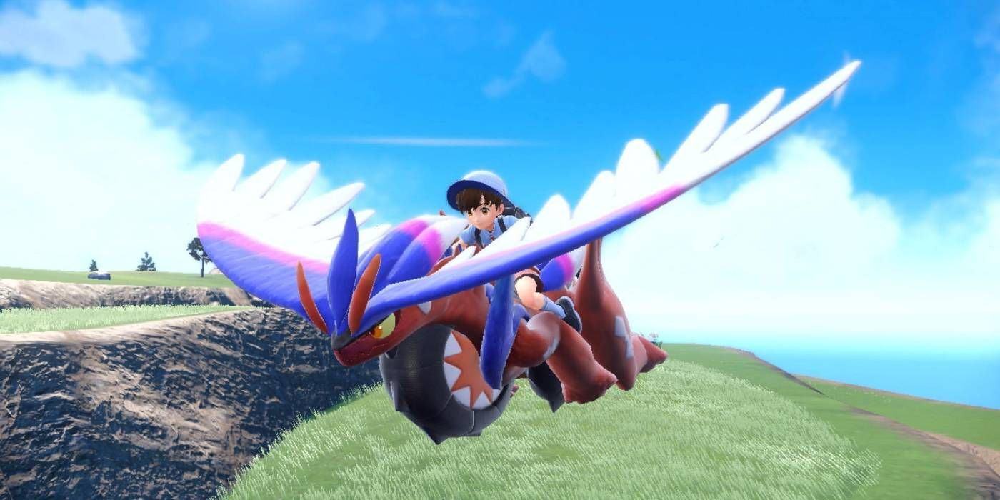 The Pokémon Trainer rides on Koraidon's back as it flies between Pokémon Scarlet and Violet.