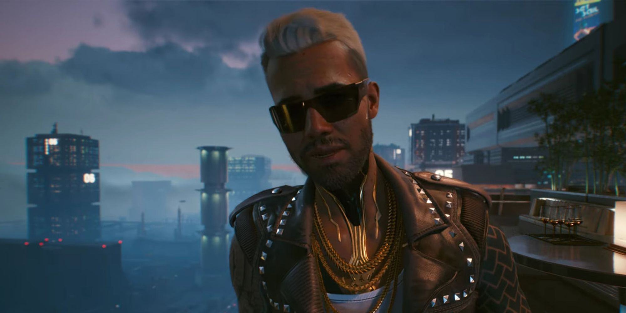 In the evening, Cyberpunk 2077's Kerry Eurodyne stands on the balcony wearing sunglasses.