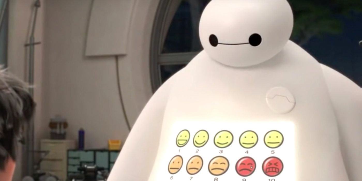 Baymax is standing with different emoticons projected on his stomach