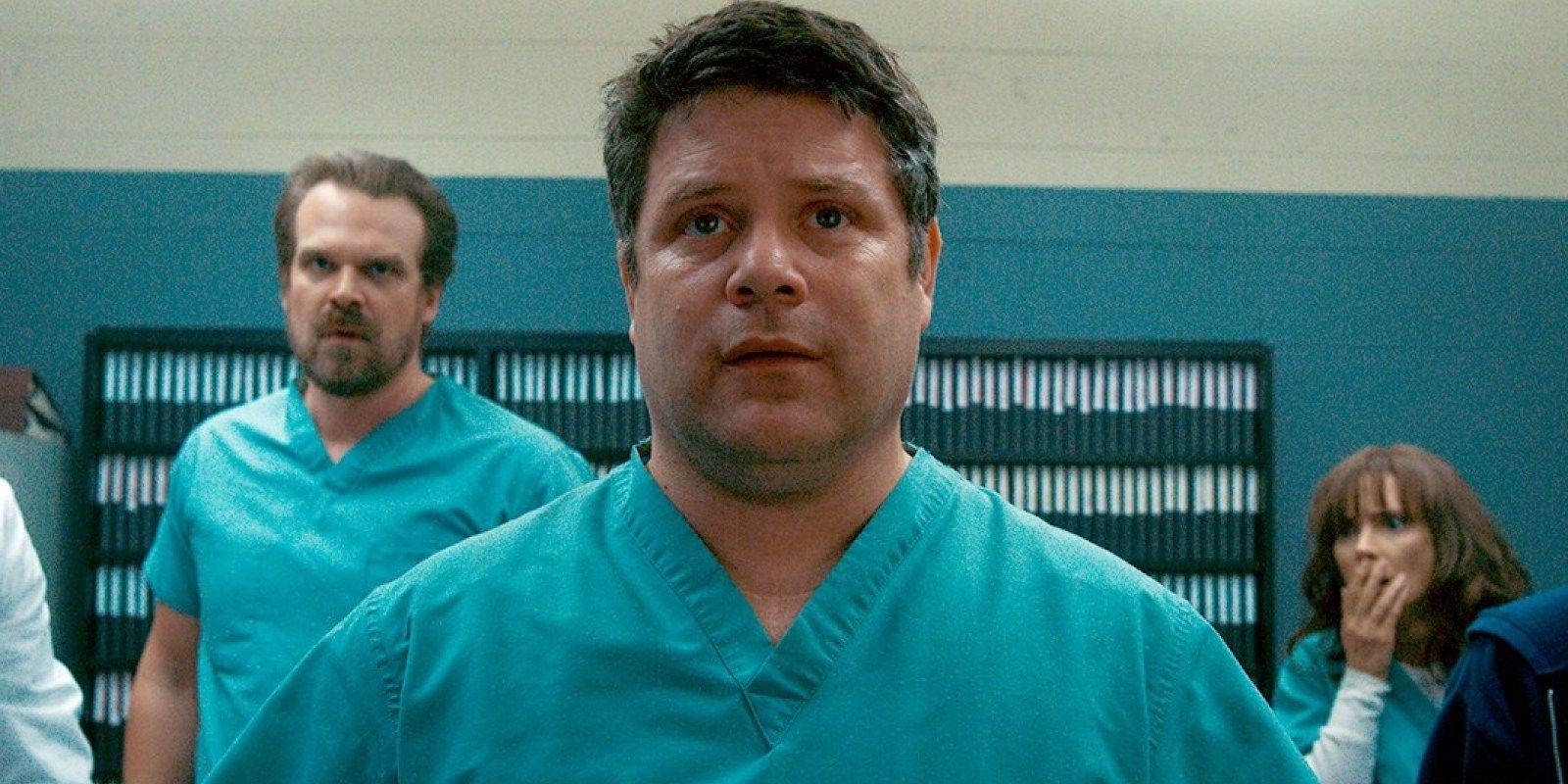 Bob Newby in his scrubs looking at something in Stranger Things