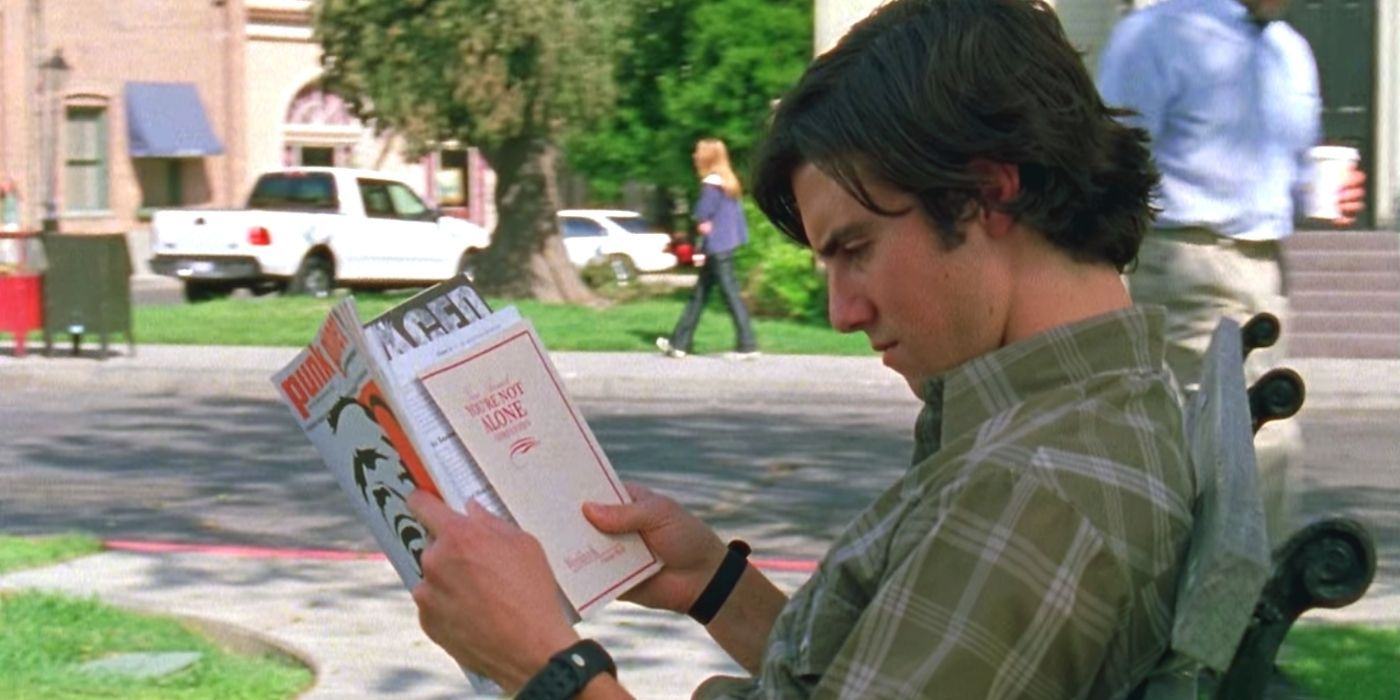 Jesse reads a Gilmore Girls book outside of Stars Hollow