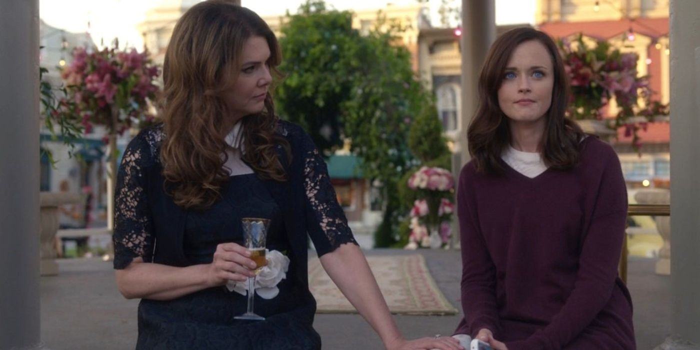 Lorelai and Rory sit outside the town square in Gilmore Girls: A Year in the Life