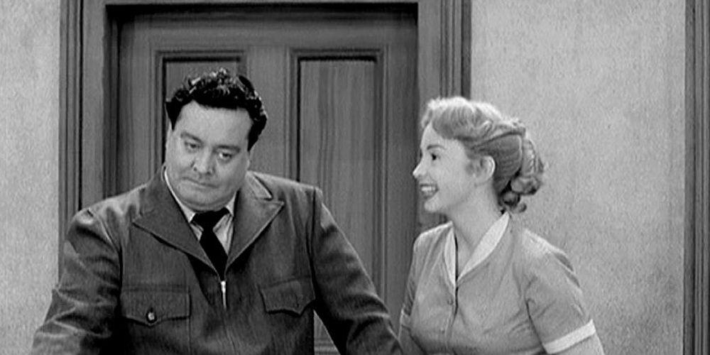 Alice Cramden (Audrey Meadows) smiles happily with her husband Ralph (Jackie Gleason)