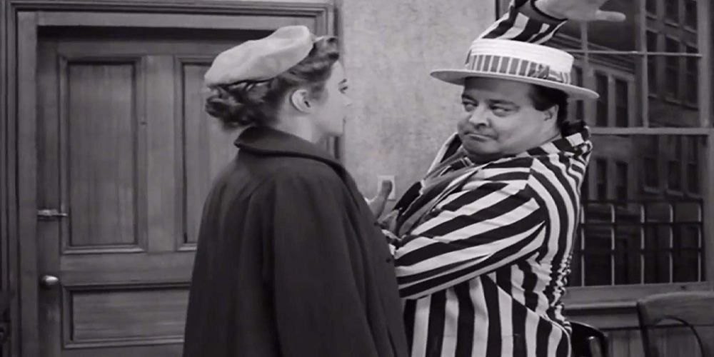 Ralph Cramden (Jackie Gleeson) dances in front of his wife Alice (Audrey Meadows) in a barbershop quartet