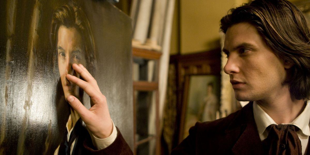 Dorian touches his portrait in Dorian Gray