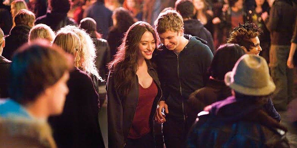 Kat Dennings and Michael Cera walk through the crowd in stills from Nick and Norah's Infinite Playlist