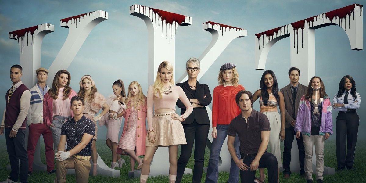 Scream Queens cast promotional photo, posing in front of Greek letters covered in blood