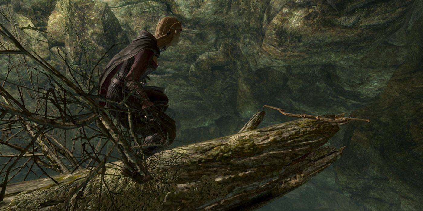 A player crouching on a log, which hangs over a cliff, and finding the Zephyr bow in Skyrim