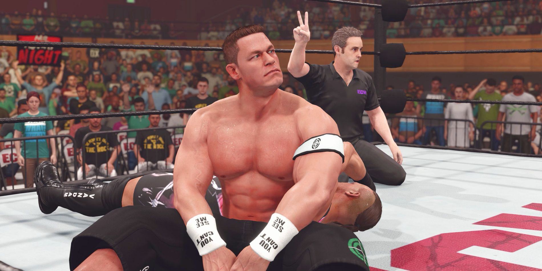 Wrestler John Cena appeared frustrated in the ring with RVD after his opponent escaped on a count of two.  The referee is seen holding up two fingers at the back.