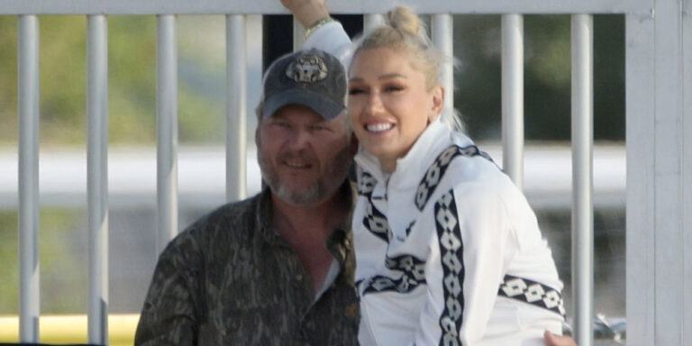 Gwen Stefani sits on Blake Shelton’s lap and shares a kiss while attending her son’s soccer game.