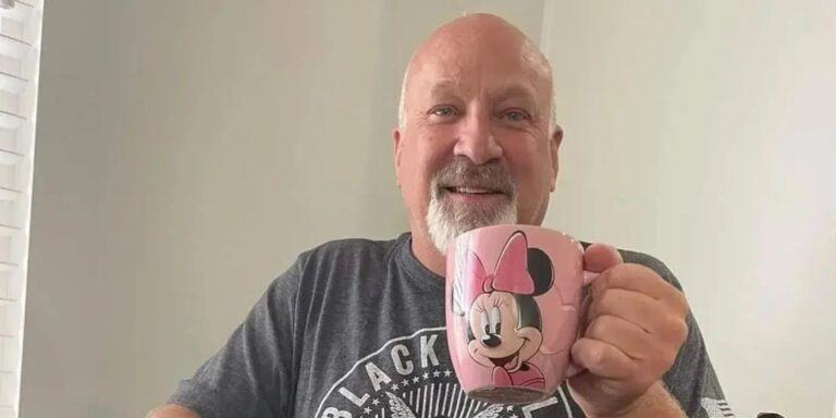 Sister Wives Christine Brown boyfriend David Woolley holding a Minnie Mouse mug and smiling